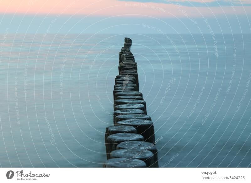 Buhne in the evening Break water Ocean Baltic Sea Water coast Deserted vacation Vacation & Travel evening sky Horizon Blue Evening Long exposure centred