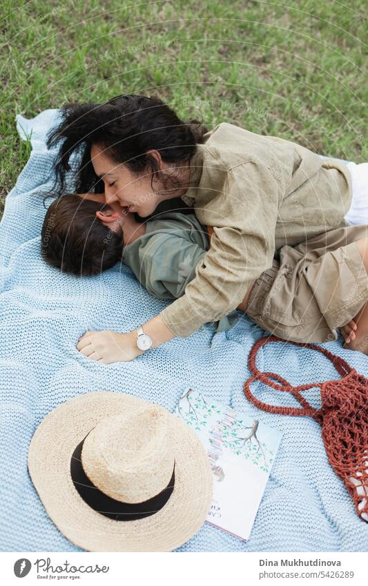 mother and son in the green park in summer on vacation on picnic. Happy family. Mother's Day. Motherhood concept. Boy (child) boy kid childhood mother and child