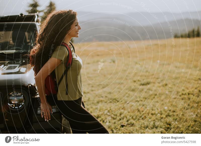 Young woman relaxing on a terrain vehicle hood at countryside adult adventure attractive auto automobile beautiful break calm car caucasian day enjoy female