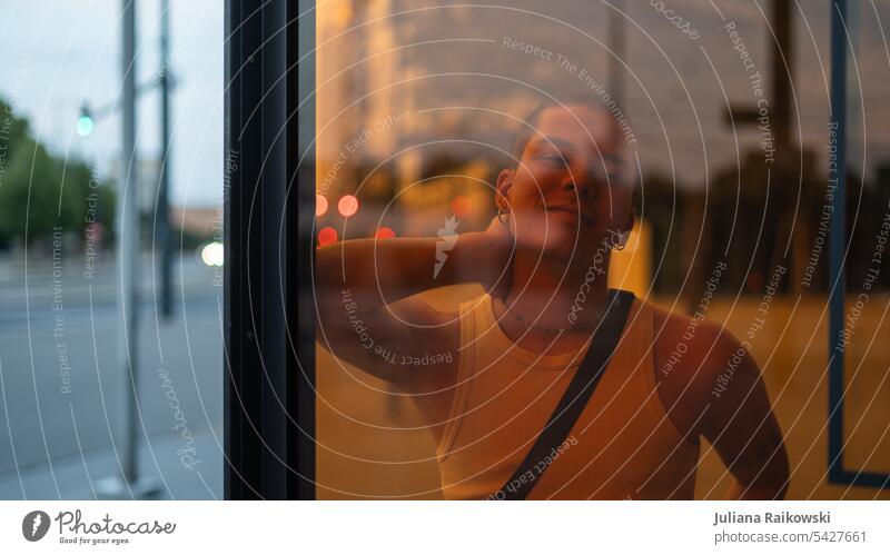 young man behind an orange window slack Smiling model fashionable Tank top Exterior shot Hair and hairstyles travel Happy Caucasian Happiness Looking Attractive