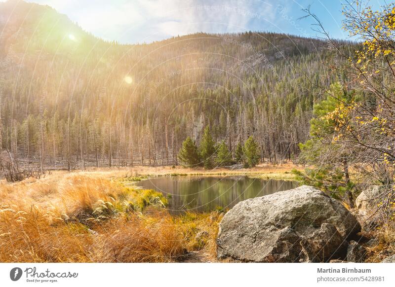 Lake in the Rocky Mountains National Park, Colorado mountain range dramatic sky orange rocky mountain national park lake travel sun flares blue water colorado