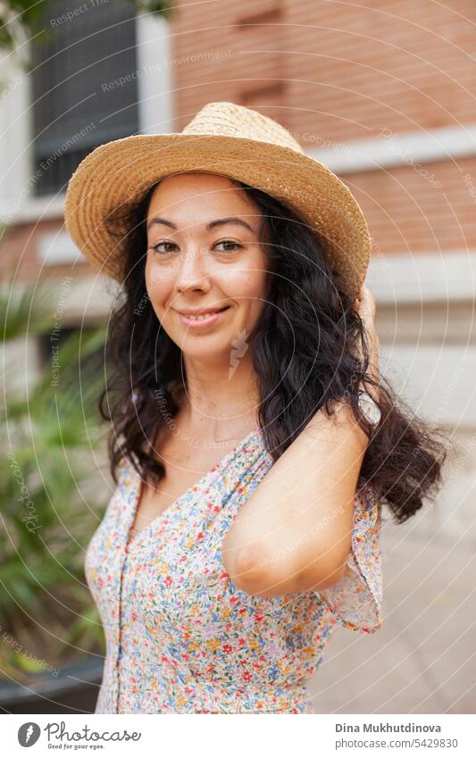 Beautiful female tourist in straw hat in Valencia, Spain. Brunette woman summer dress walking the street. beautiful gorgeous Tourism Tourist Sightseeing