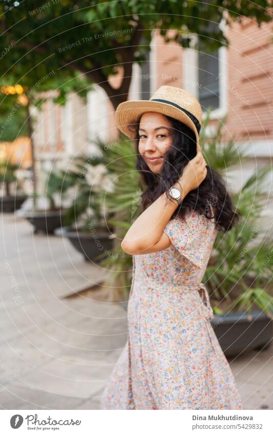 Beautiful female tourist in straw hat in Valencia, Spain. Brunette woman summer dress walking the street. beautiful gorgeous Tourism Tourist Sightseeing