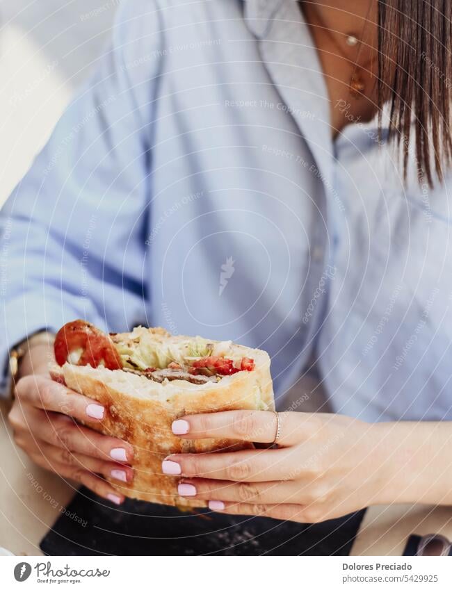 A young person enjoying a beef sandwich adult asian background bokeh bread breakfast bun burger calorie calories cheeseburger closeup delicious dinner eat