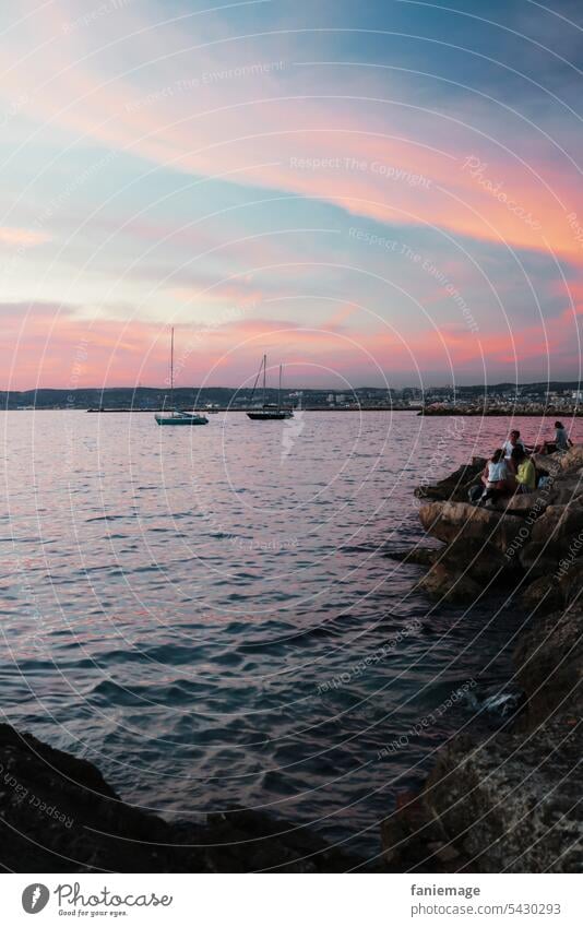 by the sea in Malmousque at sunset with sailboats in the background mousse Marseille Ocean Mediterranean sea Evening Water by the water pink sky pink clouds