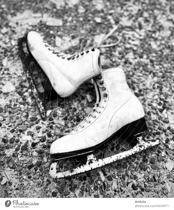 Worn out | Old worn out skates b/w Ice-skates Winter rusty Wacky White Ice-skating Broken Forget Doomed blunt Loneliness Cold Stone slab shoelaces lace-up shoes