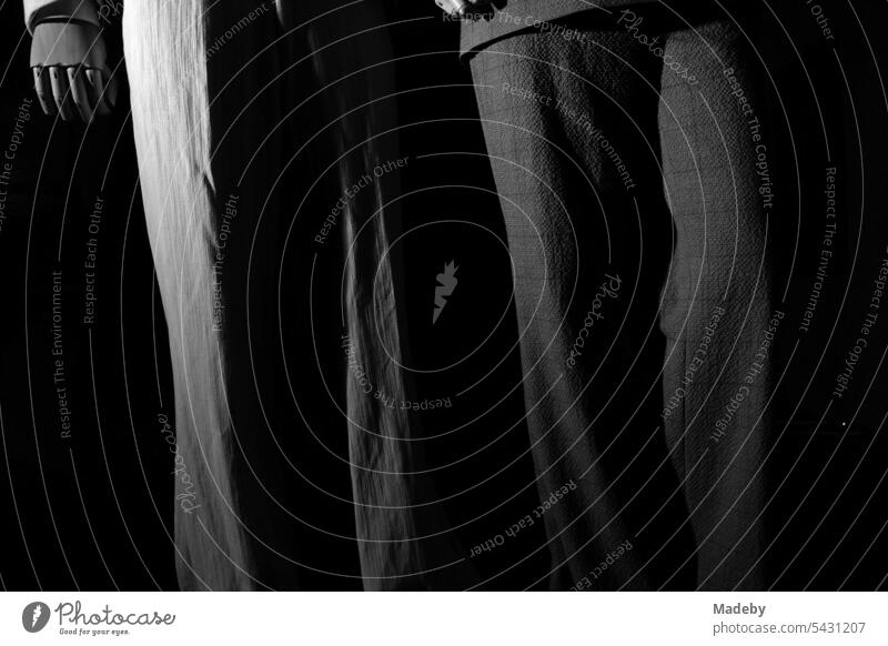 Elegant and light fashion for summer in the window of a boutique at night in the old town of Ghent in East Flanders in Belgium in neo-realistic black and white