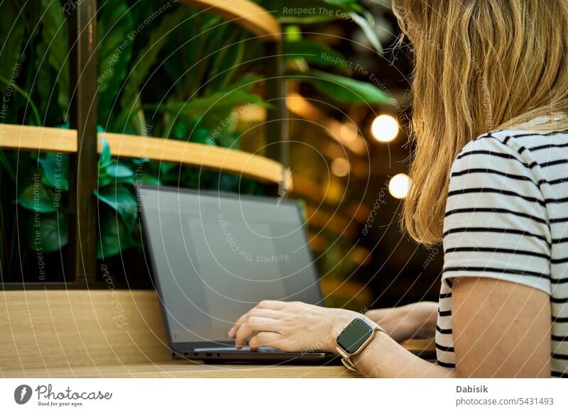 Woman usinf laptop in cafe. Freelancer in coworking use hands freelancer woman business workplace office remote typing people technology computer table