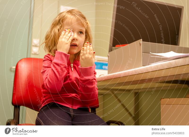 Eye exam, cute smiled little girl is reviewing eyesight. Astigmatism Astigmatismus Care Check Checkup Child Choose Clinic Consultation Control Correction