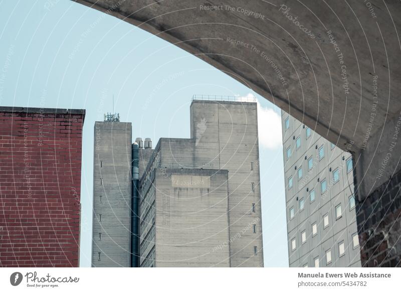 View of skyscrapers in big city Town Facades Building City Bridge Window Wall (barrier) Gray brick Blue sky Architecture Minimalistic Office Sky urban towering