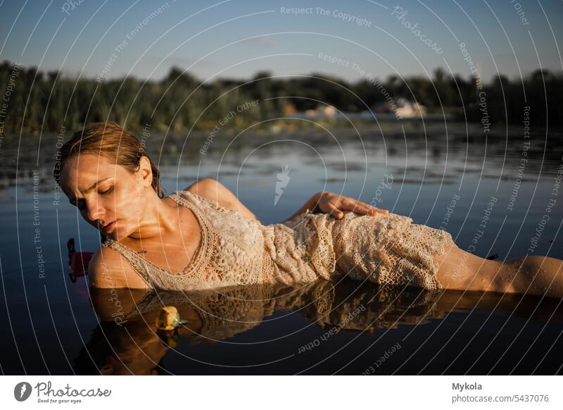 Beautiful sexy girl in white dress posing in river pond with water lilies. Fairytale story about ophelia model lily pretty wet caucasian female woman young