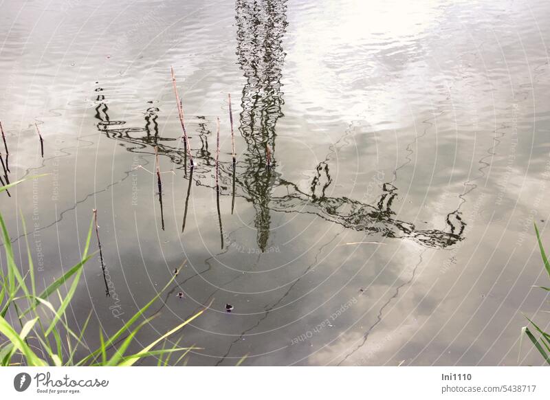 Power pole reflected in pond grey sky Technology Electricity pylon reflection Reflection in the water sureal enigmatic warped Ripple in water Power lines Water