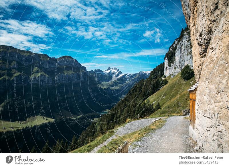 Rock face with small hut in front of a mountain panorama Mountain Alpstein hiking trail Hiking Switzerland Wall of rock Clouds Seealpsee Landscape Tourism