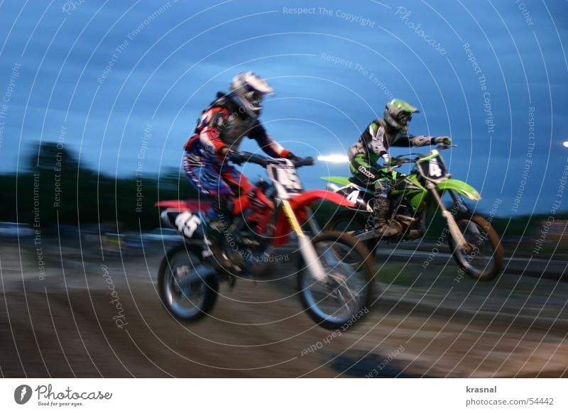 dual bike jump Mountain bike Jump Extreme Leisure and hobbies moto motorcycle mid-air Sports dirt Exterior shot Motion blur Air Evening Brave Dangerous Risk