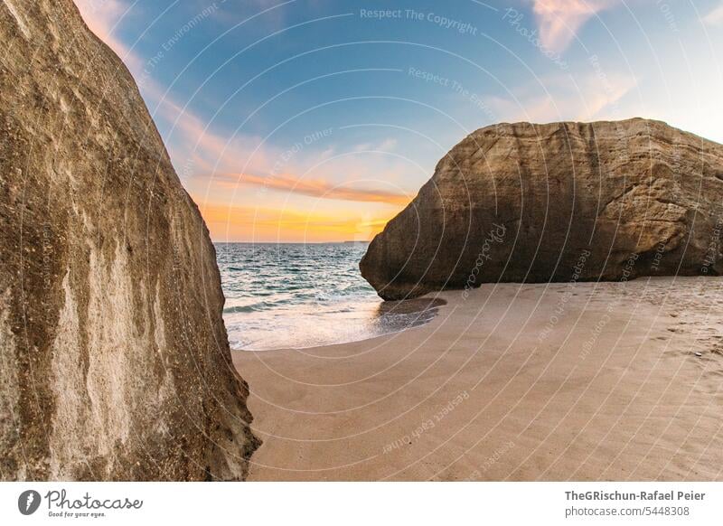 Rocks and sand by the sea in the evening Moody Sand Beach stones Water coast Oman Sky Clouds Ocean Landscape Horizon Nature Blue Summer Tourism Bay vacation