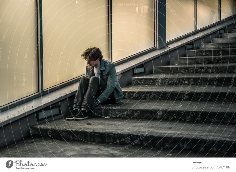 waiting Human being Masculine Young man Youth (Young adults) Man Adults Town Facade Window Dark Stairs Glas facade Diagonal Cold Sit Loneliness Wait Concern