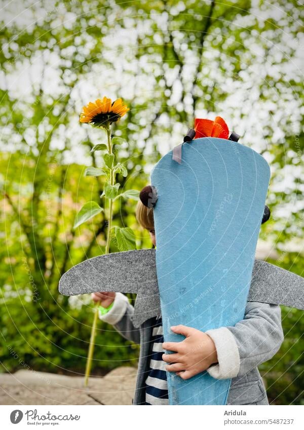 school enrollment | child clutches a big school cone, in the other hand he holds a sunflower First day at school School candy cone 1. class Child