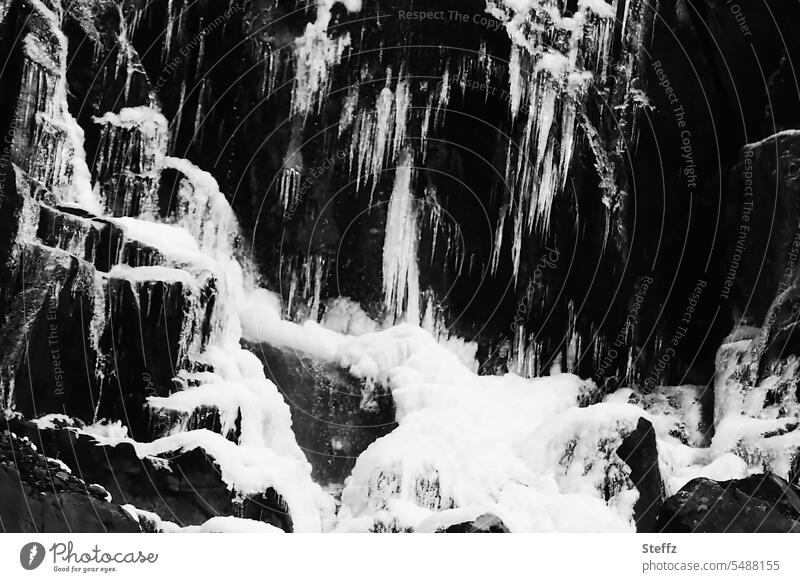 Waterfall neckline with ice and snow in Iceland waterfall neckline Icelandic ice figures chill Icicle Ice molds Frozen icy cold water ice formation iced Rock