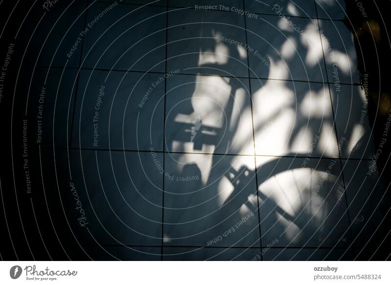 Shadow of bicycle saddle resting against the floor on sunny day sport bike seat ride transportation black background white biking closeup isolated object travel