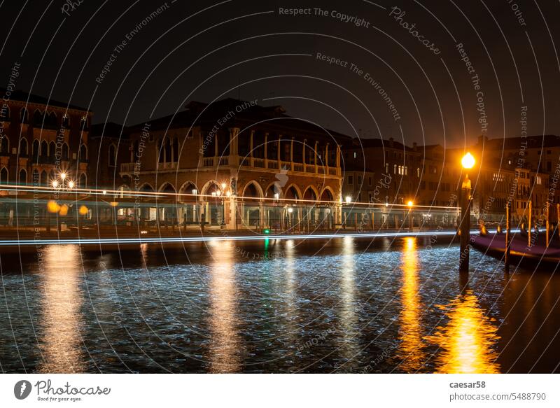 Rialto Market Hall in Venice at Night venice night grand canal vessel boat lights moving motion italy bollard arches reflection water market hall travel