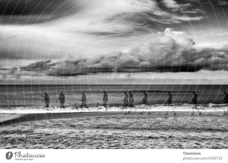 Steps on the North Sea beach Man Woman people Going stroll walk along Beach Sand Waves Water Horizon Sky Clouds Ocean coast Denmark Vacation & Travel