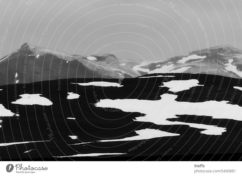 Mountains with snow melting in Iceland North Iceland Abstract Snow melt Mystic Sparse Dark Snow forms shape Iceland weather Mountain side residual snow