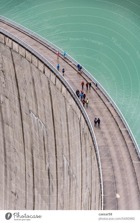 Impressing dam wall from the Mooserboden reservoir near Kaprung austria energy construction deep high people sky lake giant hiker persons water mountain view