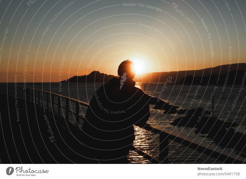 Portrait of a teenager on a promenade at dusk shadow silhouette female girl portrait sunset sky one one person no face upset feelings mental depressed sad