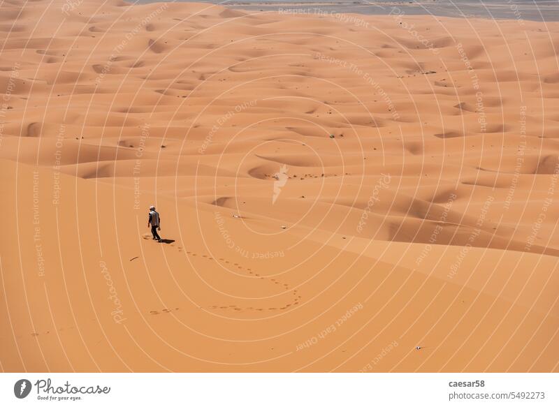 Hiking up the Great Dune of Merzouga in the Erg Chebbi desert sahara landscape dunes active wide dry morocco great africa sand view chebbi erg