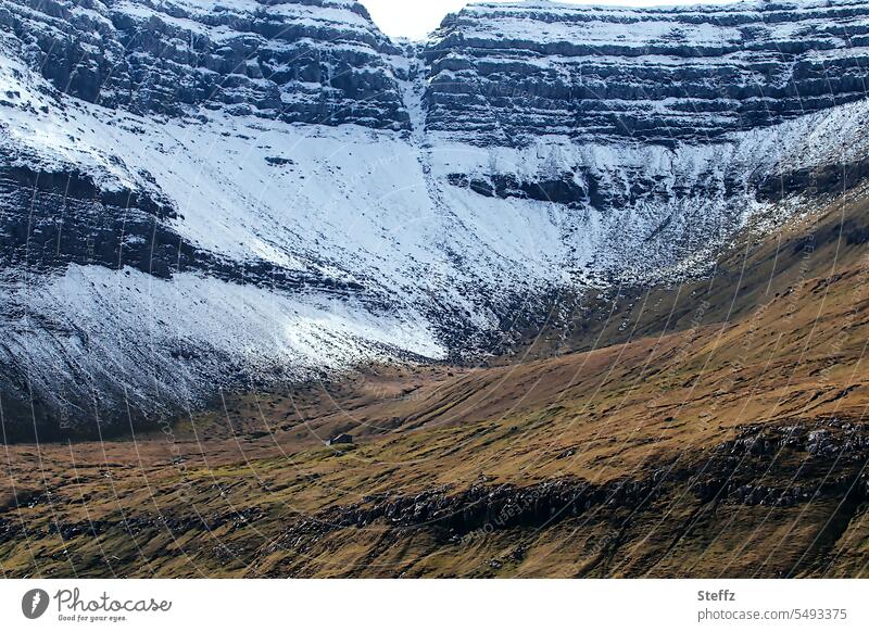 Faroe island with a small cottage färöer Faroe Islands Sheep Islands rock island snow-covered Snow Snow melt Snow layers Steep Hill mountain rock formation