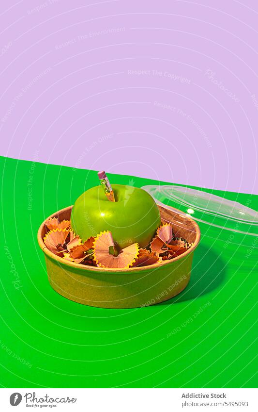 Delicious apple with pencil shavings in lunch box zero waste green healthy food organic fresh concept school diet container natural reuse creative fruit vitamin