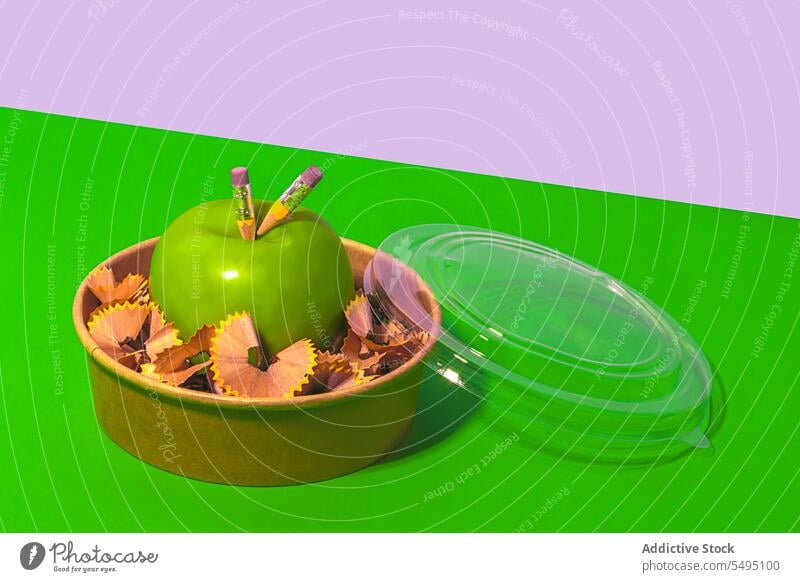 Delicious apple with pencil shavings in lunch box zero waste green healthy food organic fresh concept school diet container natural reuse creative fruit vitamin