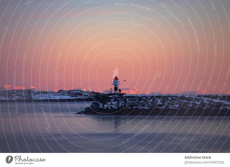 Lighthouse near sea in sunset lighthouse beacon seascape water sundown scenery seashore evening dusk winter cold freeze lofoten island norway nordic scandinavia