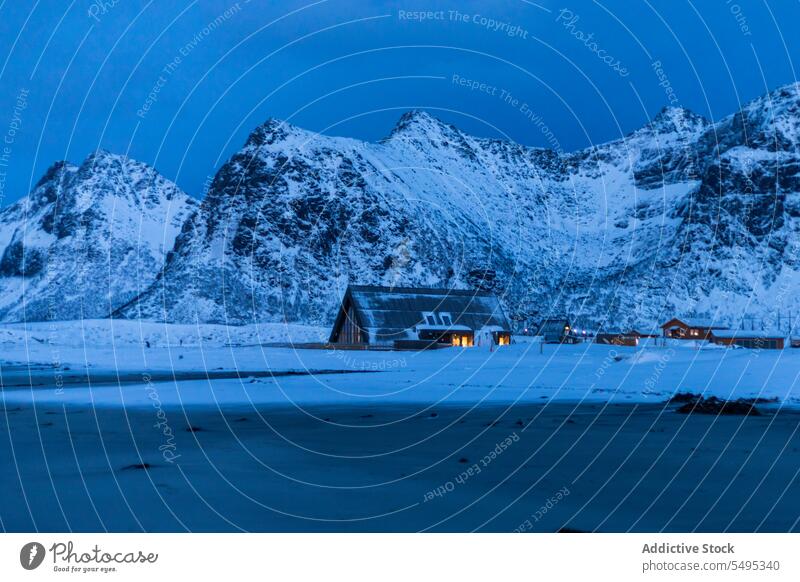 Old village near snowy mountains under sky house island winter picturesque lofoten landscape nature norway building cold shore coast ridge scenic cottage range