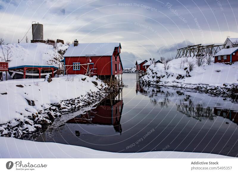 Small village on snowy river bank house settlement winter mountain fog lake amazing norway lapland lofoten island north europe atlantic nordic arctic landscape