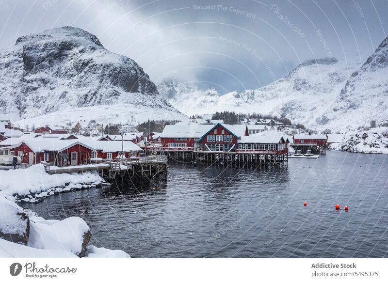 Small village on snowy river bank house settlement winter mountain fog lake amazing norway lapland lofoten island north europe atlantic nordic arctic landscape