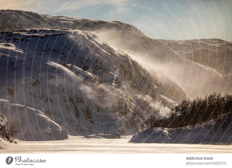 Snowy mountains under sky in winter day rocky snow forest landscape nature tree picturesque scenery norway lapland cold highland majestic ridge season