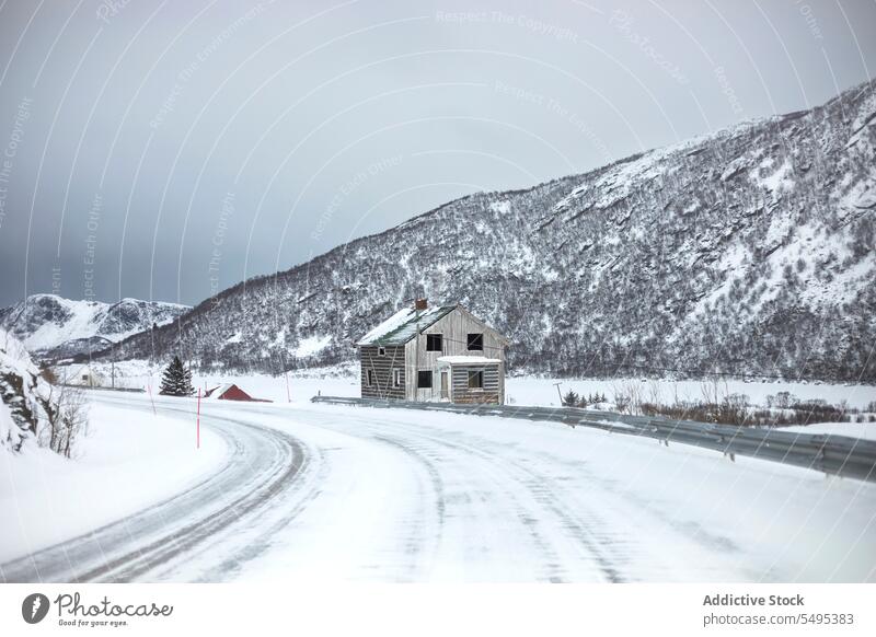 Facade of rural house in winter cottage snow facade exterior wooden road mountain norway lapland lofoten island north europe atlantic nordic arctic building