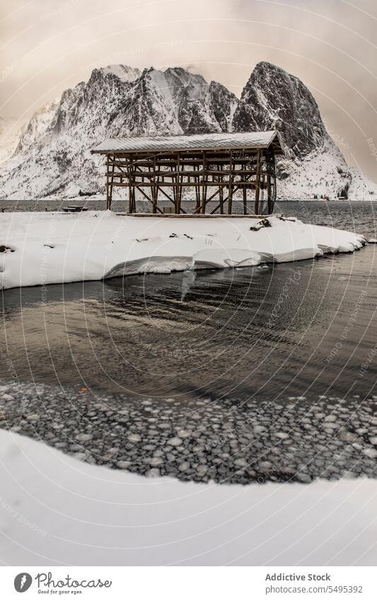 Construction on snowy shore of lake structure construction winter river mountain landscape scenic norway lapland lofoten island north europe atlantic nordic