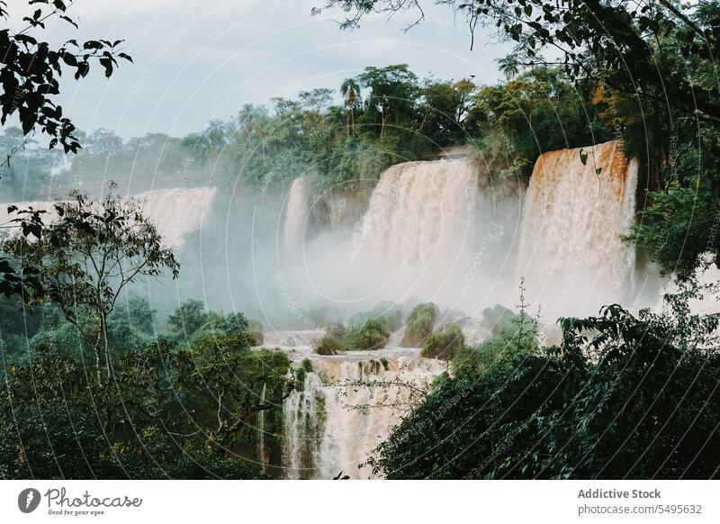 Majestic view of many cascades of water flowing under cloudy sky spectacular forest landscape environment river highland blue sky nature green daylight scenery