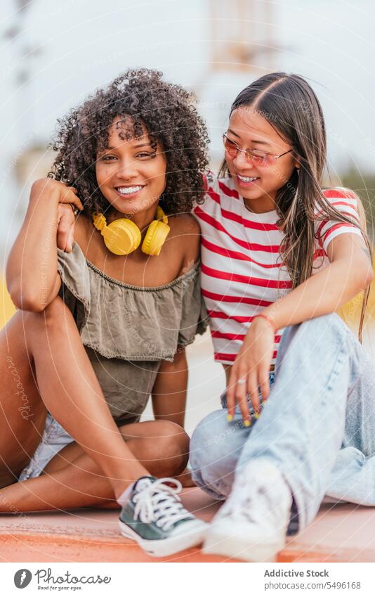 Happy young women hugging on street in city and smiling girlfriend style embrace laugh relationship happy together cheerful cool smile trendy fashion couple