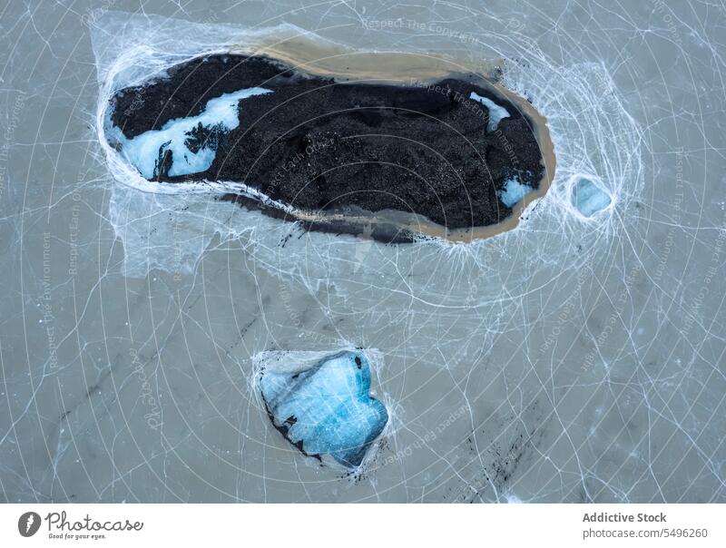 Drone view of landscape with trees and surrounded with cracked ice in daylight terrain frozen water scenery forest environment season countryside scenic cold