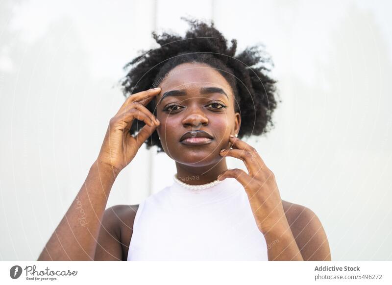 Unemotional black teenage girl in white dress teenager hairstyle hairdo happy portrait slim young female african american lady casual confident appearance calm