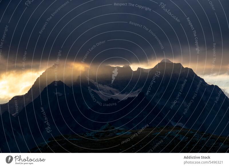 Sunset with clouds in the alps mountain rocky forest landscape nature picturesque scenery highland majestic ridge season environment scenic tranquil spectacular