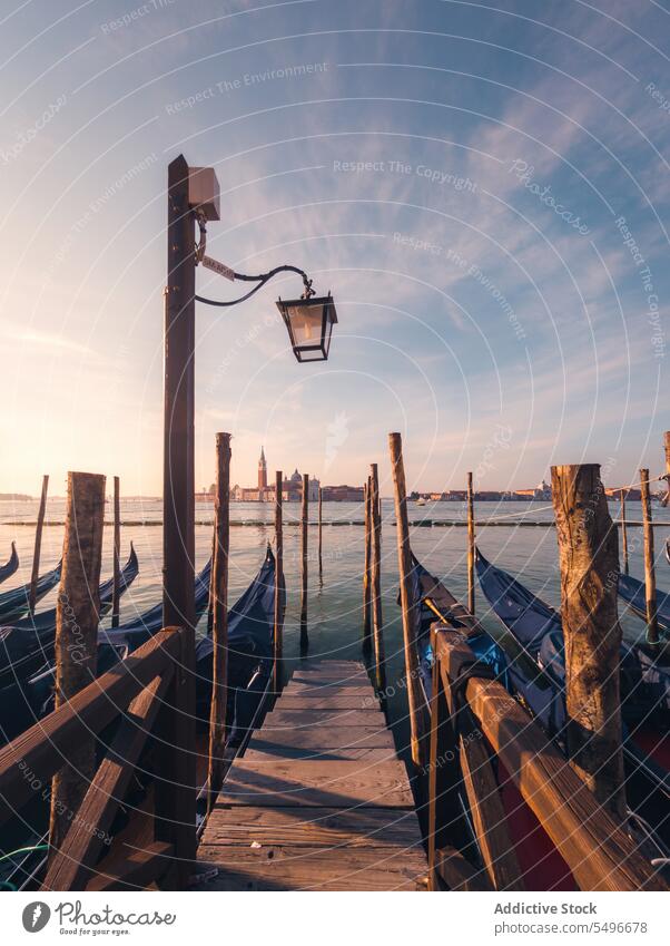 Vessel boats against old buildings in harbor gondola vessel grand canal river ancient breathtaking sunset venice morosini ferro manolesso