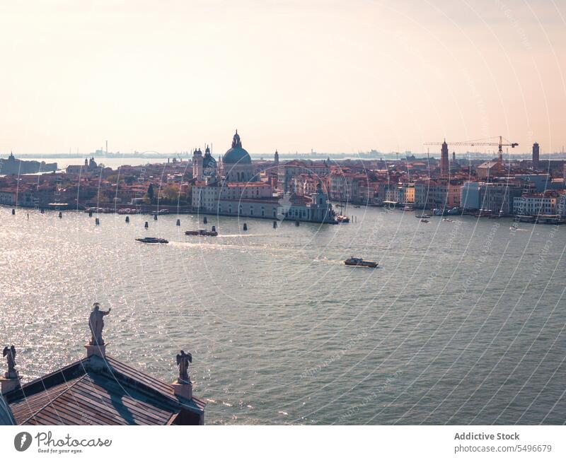 Scenic cityscape with historic buildings and rippling canal architecture boat sightseeing sunset port landmark travel picturesque tourism st marks campanile