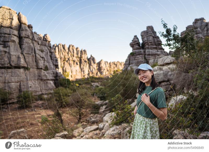 Positive woman admiring view of rocky terrain traveler admire el torcal de antequera mountain spectacular landscape summer weekend female asian