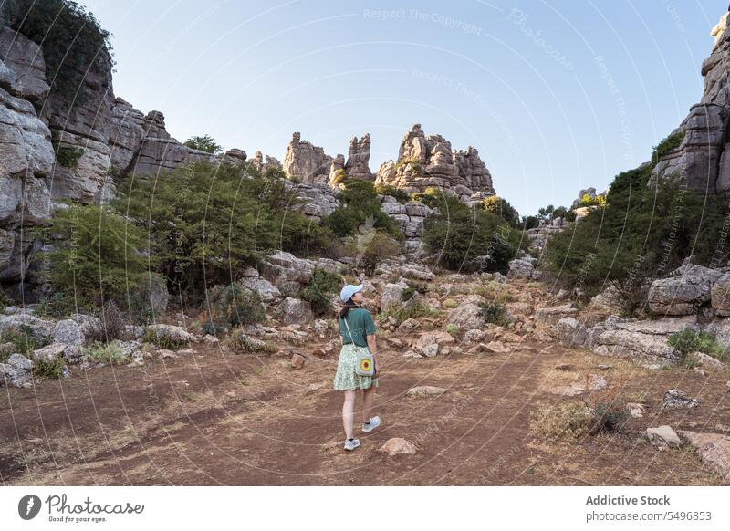 Woman admiring view of rocky terrain woman traveler admire el torcal de antequera mountain spectacular landscape summer weekend female asian sierra del torcal