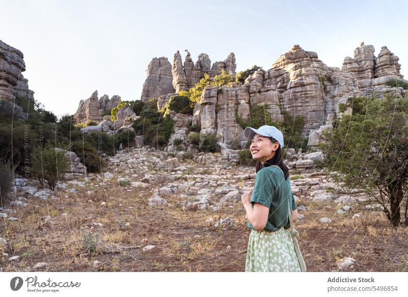 From below woman admiring view of rocky terrain traveler admire el torcal de antequera mountain spectacular landscape summer weekend female asian