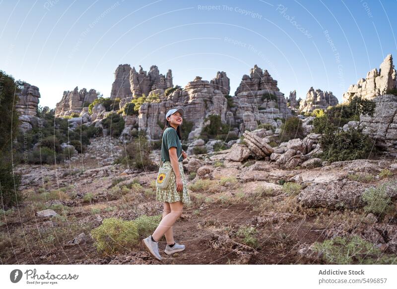 From below woman admiring view of rocky terrain traveler admire el torcal de antequera mountain spectacular landscape summer weekend female asian